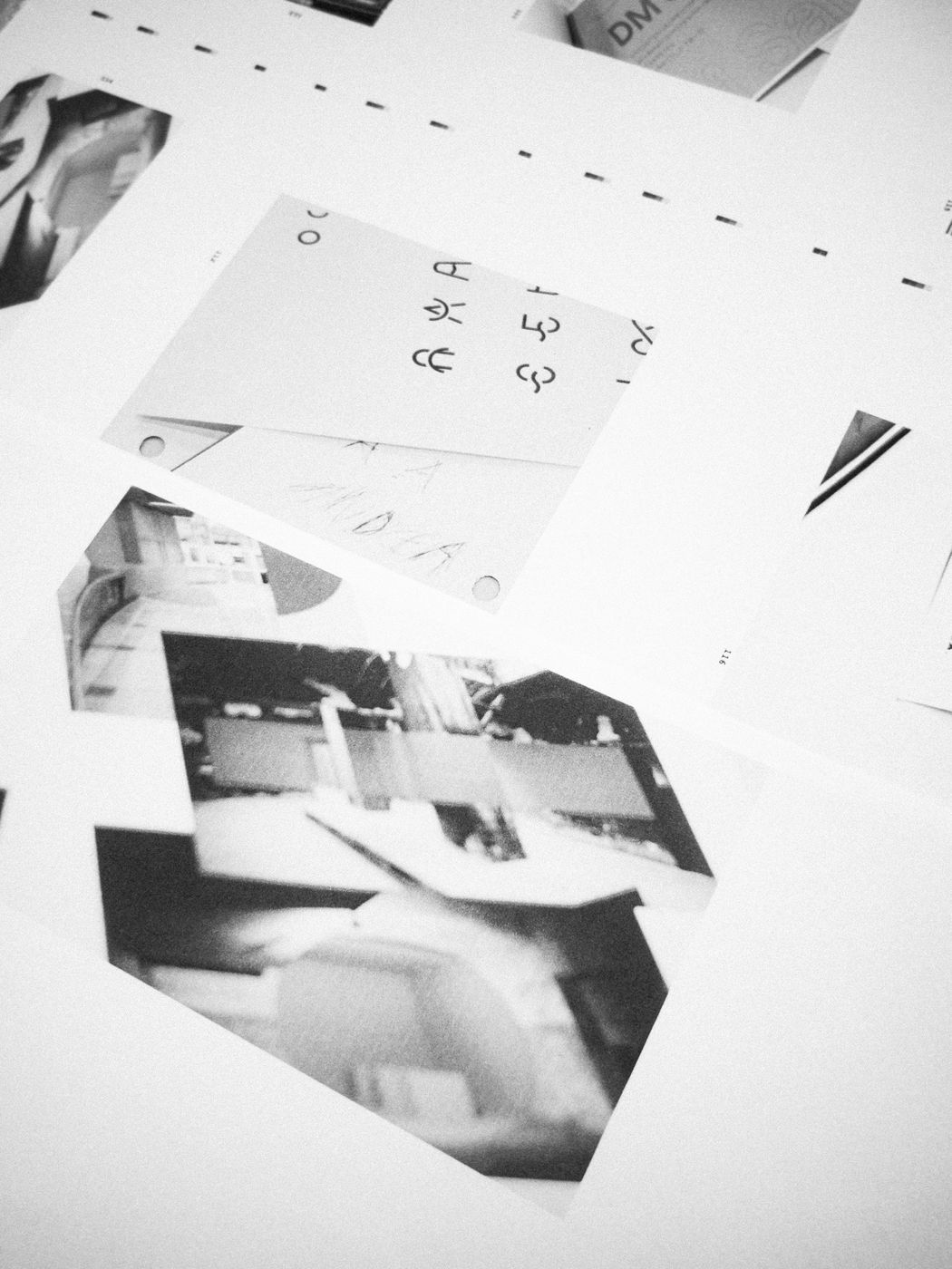 Photographies et esquisses en noir et blanc superposées sur une table.